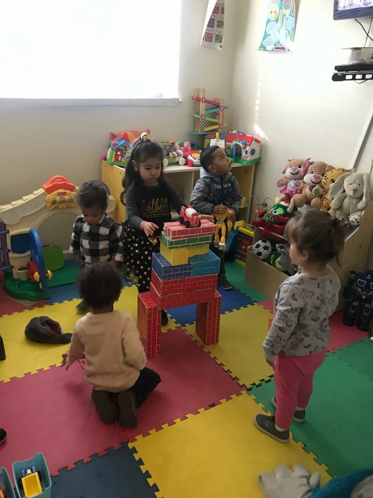Children practicing movement and coordination in the playroom