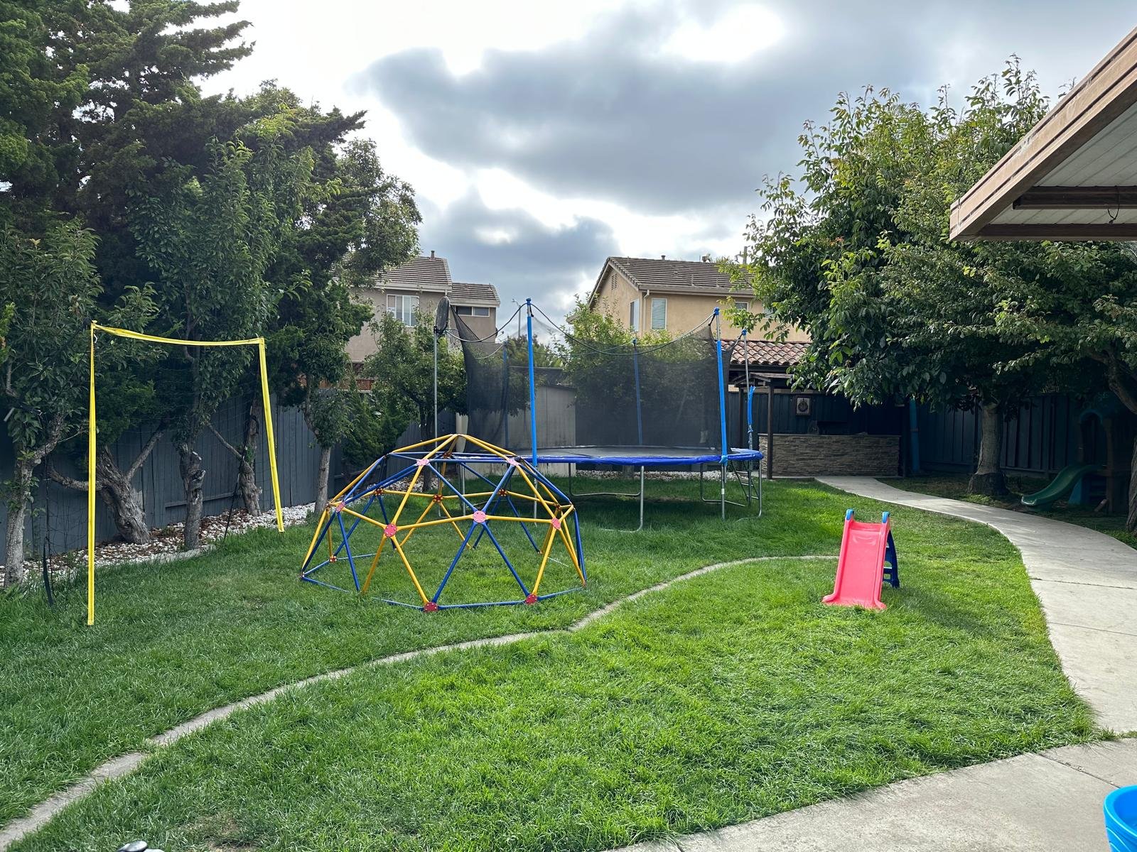 Grassy outdoor play area with climbing equipment